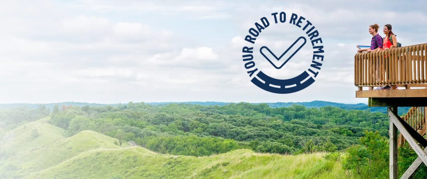 Women standing on lookout point in Iowa with Road to Retirement logo